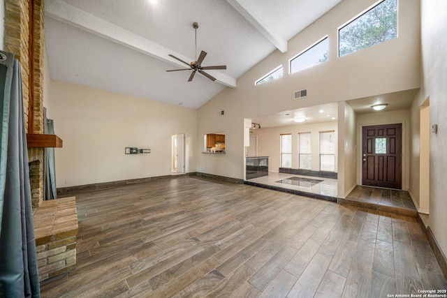 3202 Morning Crk, San Antonio, TX 78247 - unfurnished living room featuring high vaulted ceiling, a brick fireplace, ceiling fan, beamed ceiling, and wood finished floors
