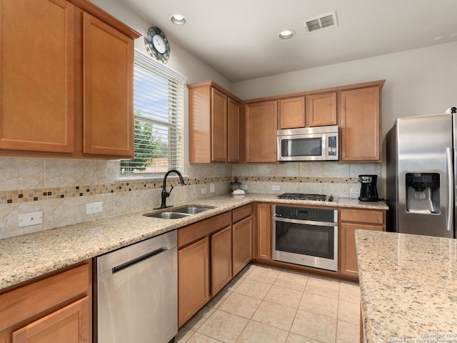 515 Secluded Grv, San Antonio, TX 78253 - kitchen with appliances with stainless steel finishes, a sink, decorative backsplash, light tile patterned floors, and recessed lighting