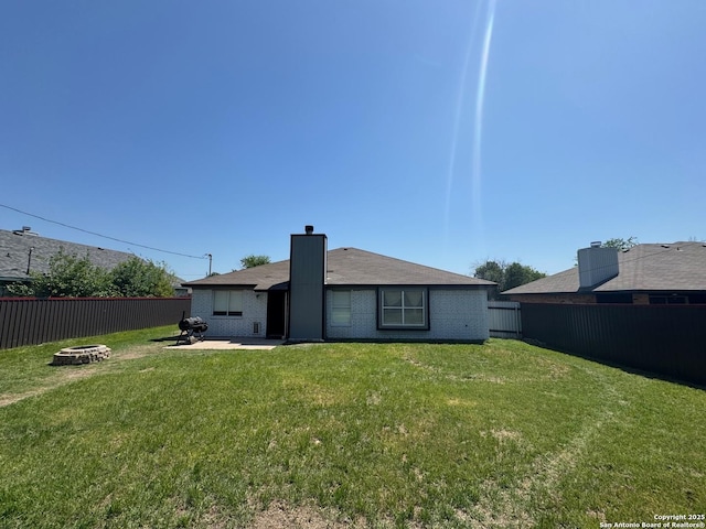 1817 Dusk Dr, Killeen, TX 76543 - back of property with an outdoor fire pit, brick siding, and a patio area