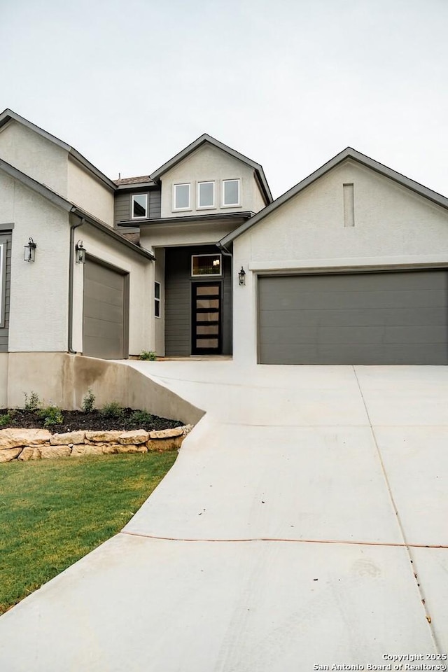 2710 Creekside Vw, San Antonio, TX 78230 - view of front of home featuring an attached garage, concrete driveway, and stucco siding