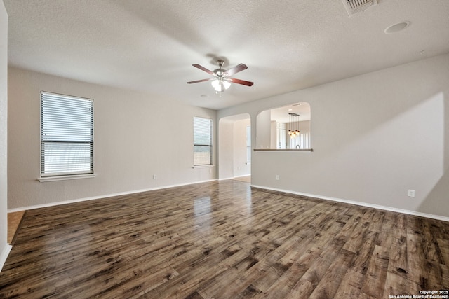 5752 Ping Way, Schertz, TX 78108 - spare room featuring ceiling fan, dark wood-type flooring, baseboards, arched walkways, and a textured ceiling