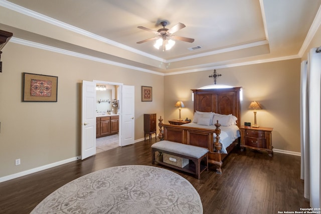 219 Roan Spg, San Antonio, TX 78258 - bedroom featuring wood finished floors, a tray ceiling, baseboards, ornamental molding, and ensuite bathroom
