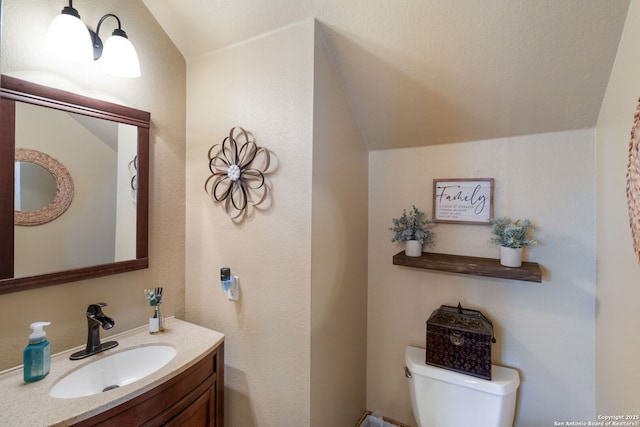 219 Roan Spg, San Antonio, TX 78258 - half bath featuring toilet, vanity, and vaulted ceiling