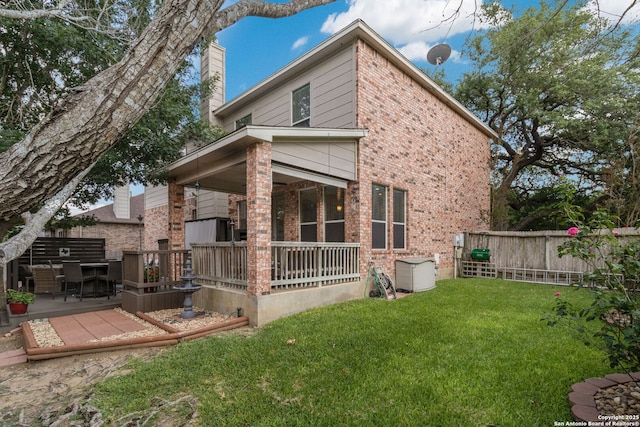 219 Roan Spg, San Antonio, TX 78258 - back of house with a chimney, a porch, and brick siding