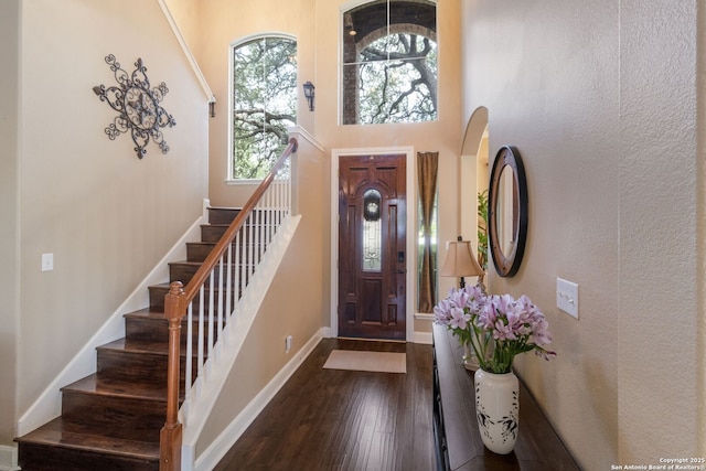 219 Roan Spg, San Antonio, TX 78258 - foyer with stairway, a high ceiling, dark wood-style floors, and baseboards