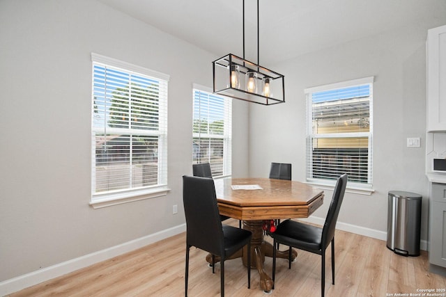 239 Porter, San Antonio, TX 78210 - dining area with light wood-type flooring, baseboards, and a chandelier