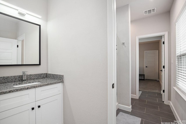 239 Porter, San Antonio, TX 78210 - bathroom with vanity, tile patterned flooring, and baseboards
