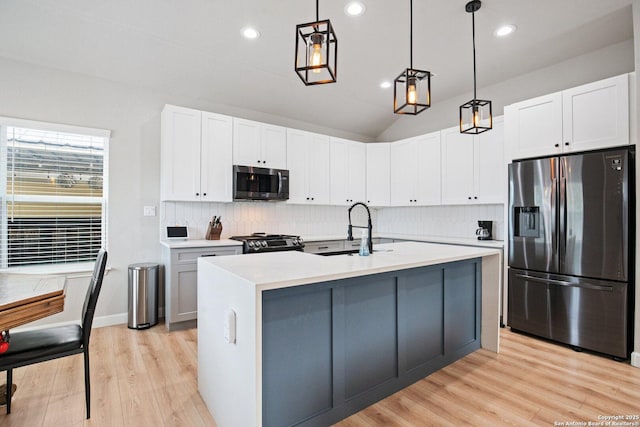 239 Porter, San Antonio, TX 78210 - kitchen with stainless steel appliances, a sink, decorative backsplash, light wood-style floors, and recessed lighting