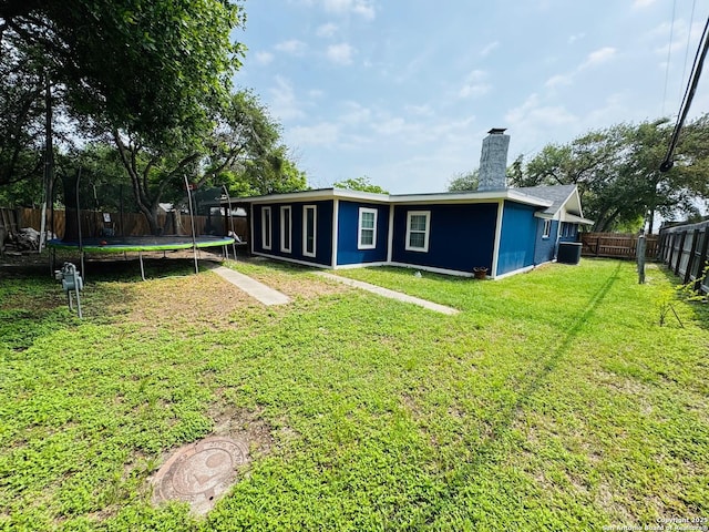 101 Ghent Pl, Portland, TX 78374 - rear view of property featuring a trampoline and a chimney