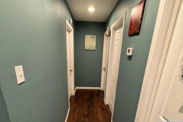 101 Ghent Pl, Portland, TX 78374 - hallway featuring dark wood-style flooring, a textured wall, and baseboards