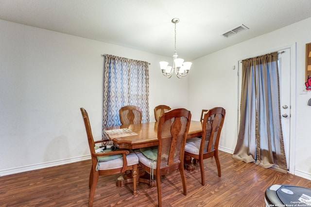 8514 Bayliss Pt, San Antonio, TX 78252 - dining area with a chandelier, wood finished floors, and baseboards