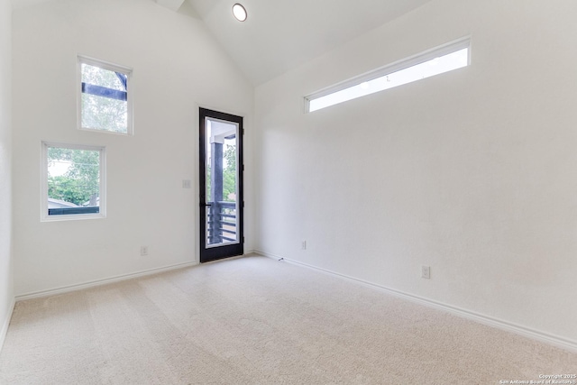 623 Recio St, San Antonio, TX 78225 - spare room featuring high vaulted ceiling, healthy amount of natural light, light colored carpet, and baseboards