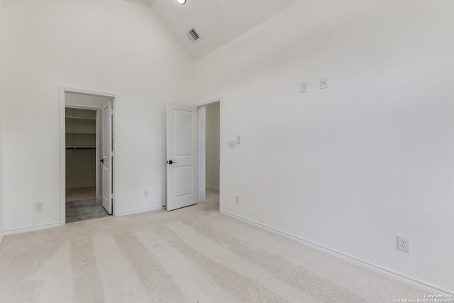 623 Recio St, San Antonio, TX 78225 - unfurnished bedroom featuring a spacious closet, high vaulted ceiling, light carpet, baseboards, and a closet