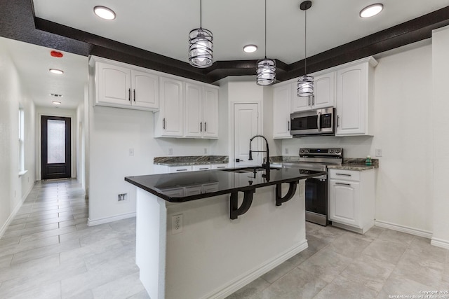 623 Recio St, San Antonio, TX 78225 - kitchen with appliances with stainless steel finishes, a sink, white cabinets, decorative light fixtures, and recessed lighting