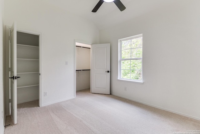 623 Recio St, San Antonio, TX 78225 - unfurnished bedroom featuring multiple closets, carpet floors, vaulted ceiling, baseboards, and a ceiling fan