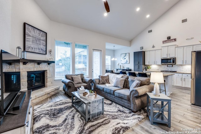 28806 Oldlyme, San Antonio, TX 78260 - living room featuring light wood finished floors, high vaulted ceiling, a stone fireplace, recessed lighting, and ceiling fan