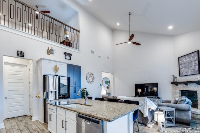 28806 Oldlyme, San Antonio, TX 78260 - kitchen featuring stainless steel dishwasher, ceiling fan, a sink, light wood-style floors, and light stone countertops