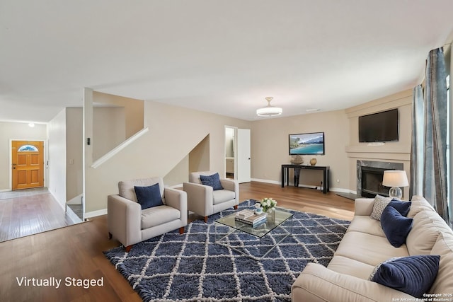 10222 Eagle Blf, San Antonio, TX 78249 - living area with wood finished floors, baseboards, stairway, and a fireplace