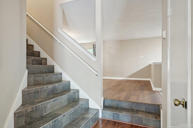 10222 Eagle Blf, San Antonio, TX 78249 - staircase with wood finished floors, a textured ceiling, and baseboards
