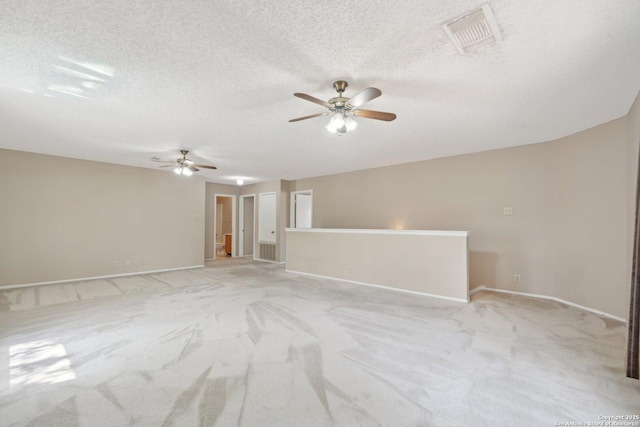10222 Eagle Blf, San Antonio, TX 78249 - spare room featuring a ceiling fan, light carpet, baseboards, and a textured ceiling