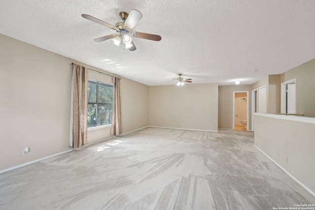 10222 Eagle Blf, San Antonio, TX 78249 - empty room featuring a ceiling fan, a textured ceiling, light carpet, and baseboards