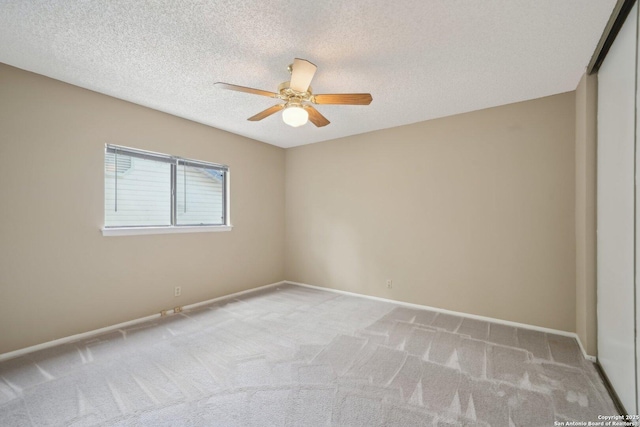 10222 Eagle Blf, San Antonio, TX 78249 - empty room featuring a ceiling fan, light colored carpet, baseboards, and a textured ceiling