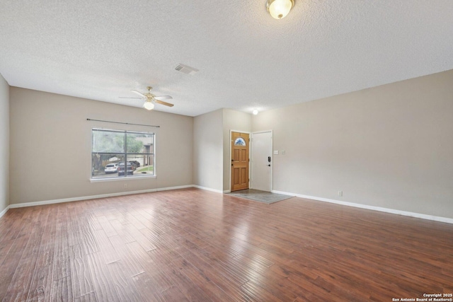 10222 Eagle Blf, San Antonio, TX 78249 - spare room with ceiling fan, a textured ceiling, wood finished floors, and baseboards
