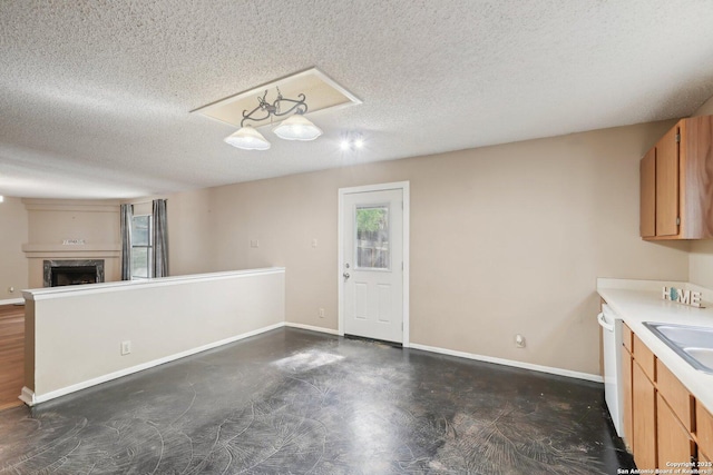 10222 Eagle Blf, San Antonio, TX 78249 - kitchen featuring dishwasher, a textured ceiling, baseboards, and light countertops