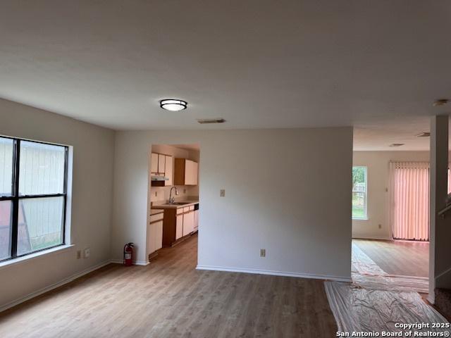 7011 Cole Crk, Converse, TX 78109 - unfurnished living room featuring light wood finished floors and baseboards