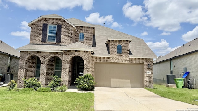 10828 Bango Farms, San Antonio, TX 78254 - view of front facade featuring brick siding, an attached garage, a front yard, and concrete driveway
