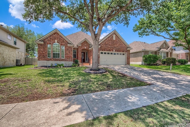 1009 Oak Rdg, Schertz, TX 78154 - view of front of property featuring an attached garage, brick siding, driveway, and central AC