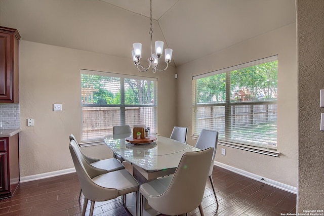 1009 Oak Rdg, Schertz, TX 78154 - dining space with lofted ceiling, a chandelier, baseboards, dark wood-style floors, and a textured wall