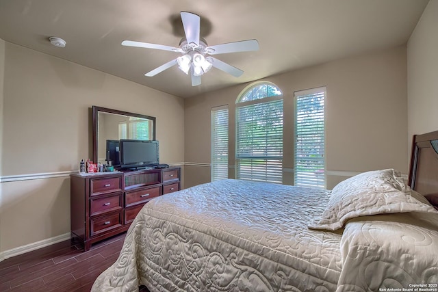 1009 Oak Rdg, Schertz, TX 78154 - bedroom featuring dark wood-style flooring, baseboards, and ceiling fan