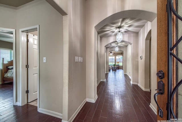 1009 Oak Rdg, Schertz, TX 78154 - hallway with arched walkways, dark wood-type flooring, and baseboards