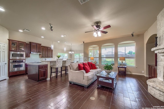 1009 Oak Rdg, Schertz, TX 78154 - living area featuring ceiling fan, dark wood-style flooring, recessed lighting, a stone fireplace, and baseboards