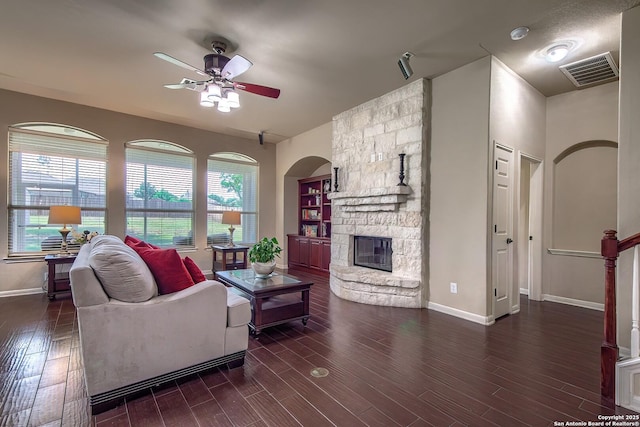 1009 Oak Rdg, Schertz, TX 78154 - living area featuring ceiling fan, a stone fireplace, wood finished floors, and baseboards