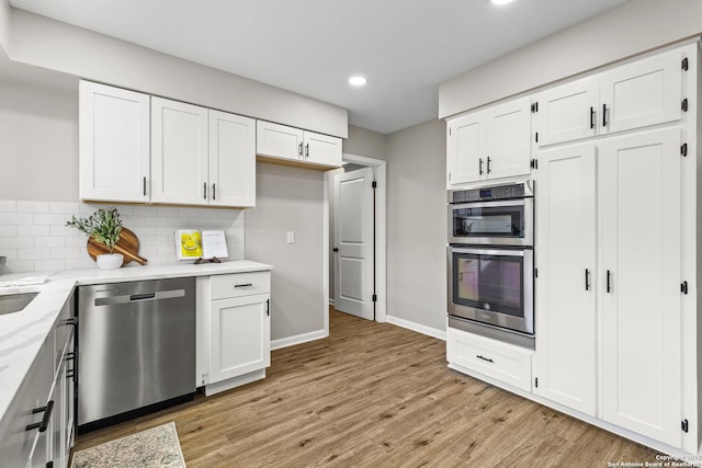 371 Pike, San Antonio, TX 78209 - kitchen with stainless steel appliances, recessed lighting, white cabinets, and light wood finished floors