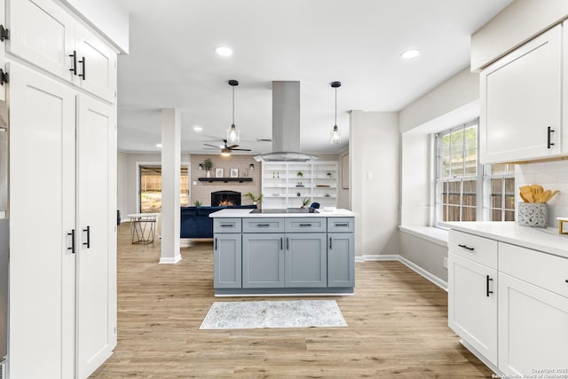 371 Pike, San Antonio, TX 78209 - kitchen with ceiling fan, baseboards, a brick fireplace, white cabinets, and recessed lighting
