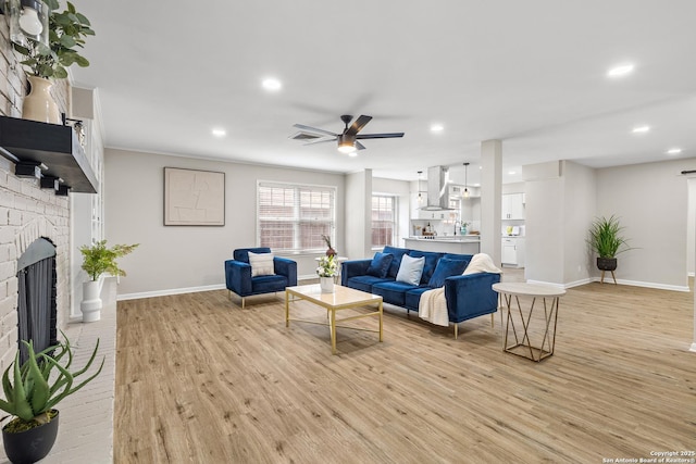 371 Pike, San Antonio, TX 78209 - living room featuring a fireplace, light wood finished floors, baseboards, a ceiling fan, and recessed lighting