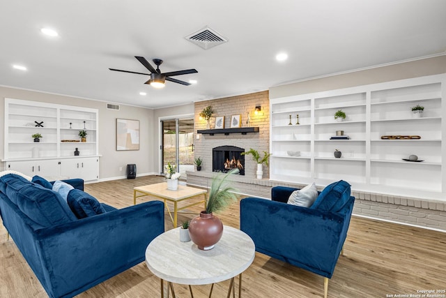 371 Pike, San Antonio, TX 78209 - living room with a ceiling fan, a fireplace, light wood-style floors, built in features, and baseboards