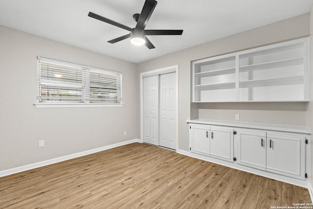 371 Pike, San Antonio, TX 78209 - unfurnished bedroom featuring light wood-type flooring, baseboards, a closet, and a ceiling fan