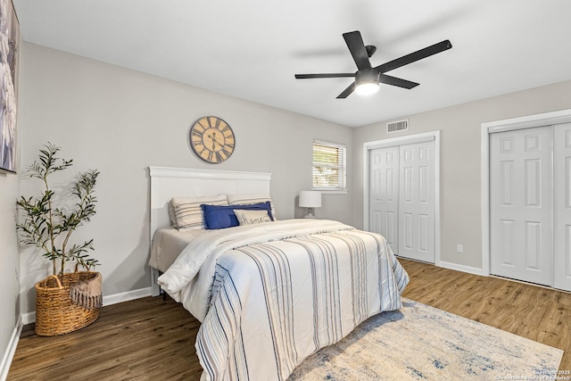 371 Pike, San Antonio, TX 78209 - bedroom featuring wood finished floors, baseboards, two closets, and a ceiling fan