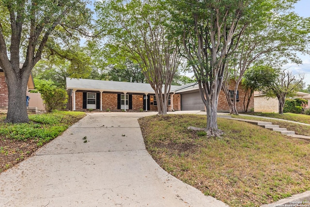 371 Pike, San Antonio, TX 78209 - view of front facade with driveway, brick siding, and an attached garage