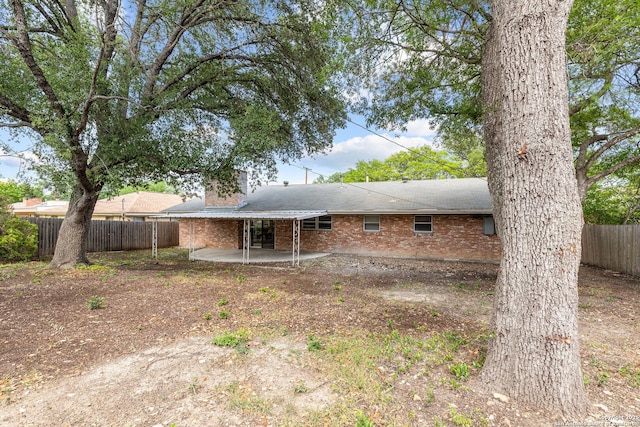 371 Pike, San Antonio, TX 78209 - rear view of house featuring a patio area, a fenced backyard, brick siding, a chimney, and roof with shingles