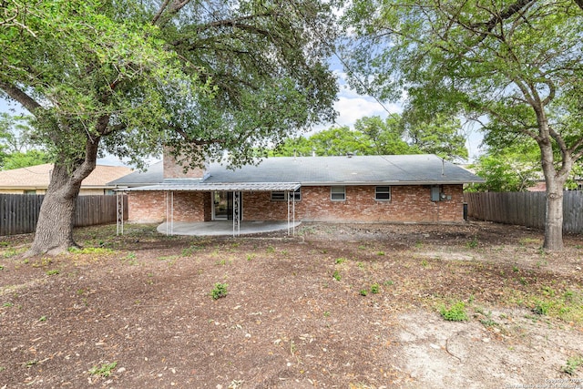 371 Pike, San Antonio, TX 78209 - back of property featuring a patio, a fenced backyard, brick siding, and a chimney