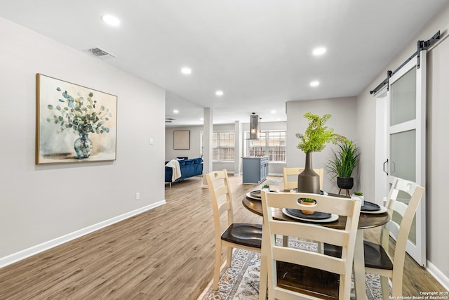 371 Pike, San Antonio, TX 78209 - dining space with a barn door, baseboards, light wood finished floors, and recessed lighting
