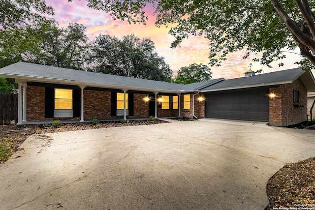 371 Pike, San Antonio, TX 78209 - view of front of house with brick siding, a garage, and concrete driveway