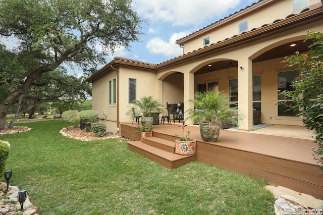 22450 Viajes, San Antonio, TX 78261 - back of house featuring a yard, a wooden deck, stucco siding, and a tile roof