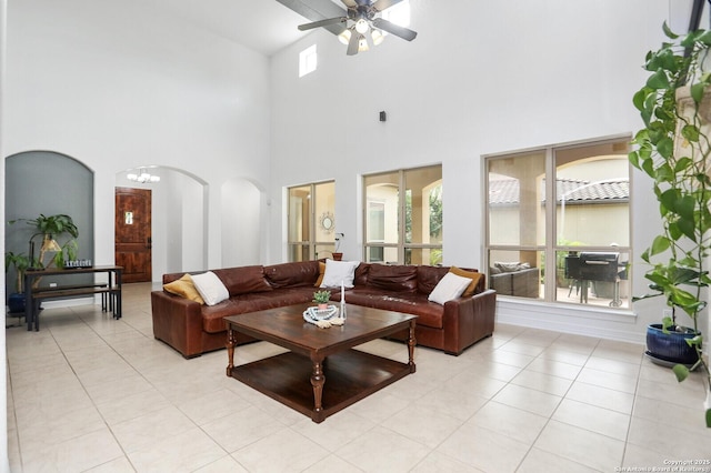 22450 Viajes, San Antonio, TX 78261 - living room featuring arched walkways, ceiling fan, light tile patterned flooring, and a high ceiling