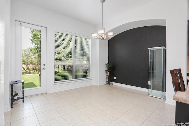 22450 Viajes, San Antonio, TX 78261 - unfurnished dining area with a chandelier, light tile patterned flooring, and baseboards